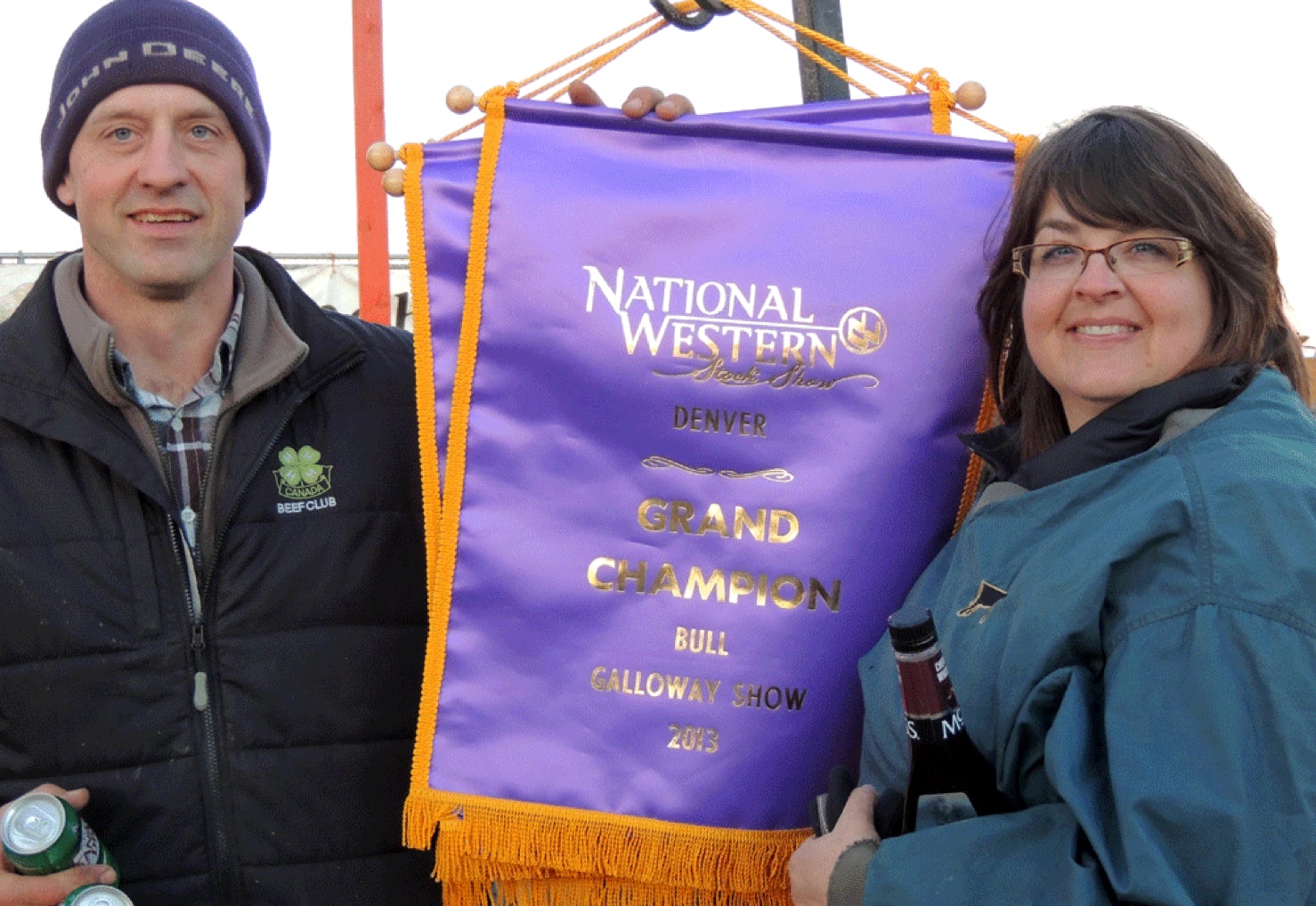 Ciaran (Mcilwraith) Yool and John A Mcilwraith with the Grand Champion Bull banner at the National Western Stock Show, Denver
