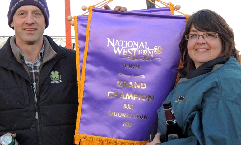 Ciaran (Mcilwraith) Yool and John A Mcilwraith with the Grand Champion Bull banner at the National Western Stock Show, Denver